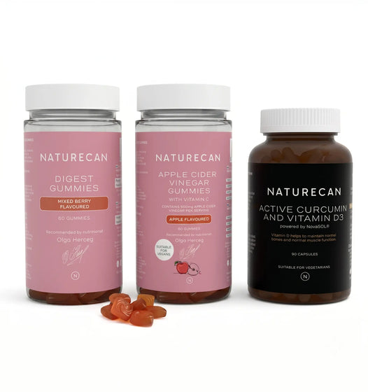 Three bottles of Naturecan supplements, labeled as Digest Gummies, Apple Cider Vinegar Gummies, and Active Curcumin and Vitamin D3, with the gummies visible in one bottle and capsules in another