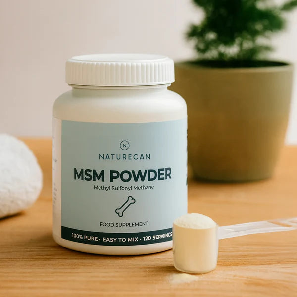 Naturecan MSM Powder supplement bottle on a wooden surface with a plant in the background