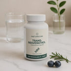 Naturecan Trans-Resveratrol supplement bottle on a marble surface with blueberries and rosemary.