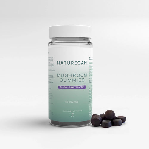 A bottle of Naturecan Mushroom Gummies with blackcurrant flavor, alongside several gummy candies visible outside the bottle.